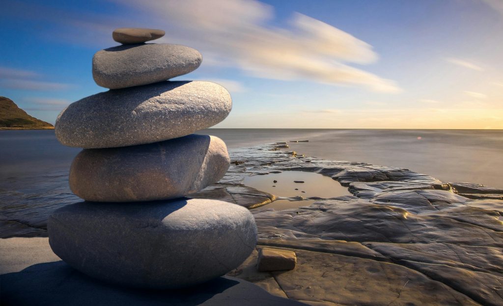 Photo of stones stacked in beautiful landscape