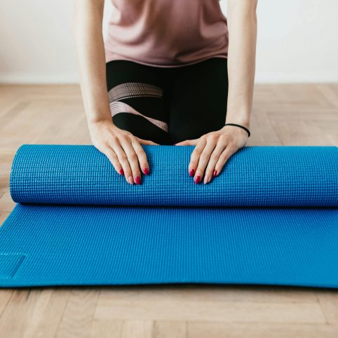 Woman with pilates mat