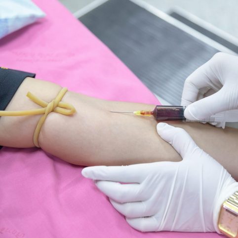 Photo of child getting an injection in arm with needle