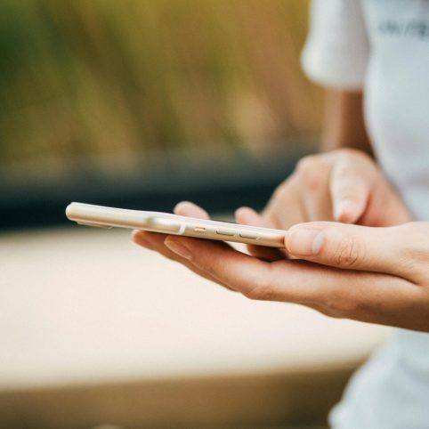 Photo of woman using her phone